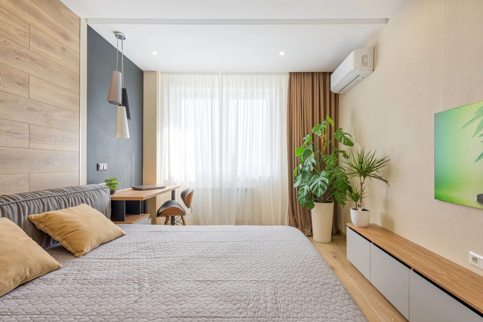Bedroom with a newly installed mini split indoor unit mounted high near the window