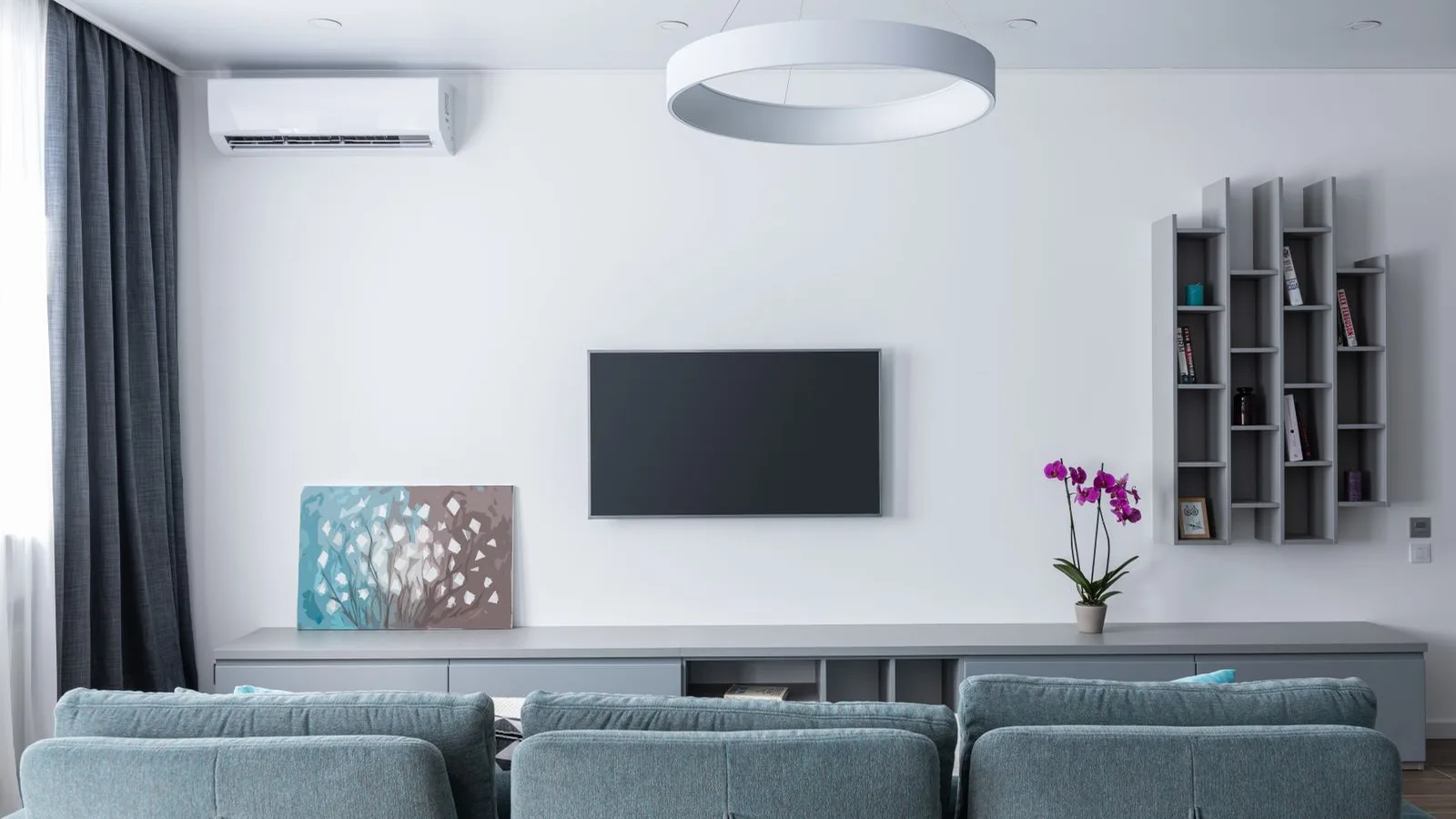 Wall-mounted mini split unit on white interior wall, showing equipment used when drilling mini split hole in stucco wall