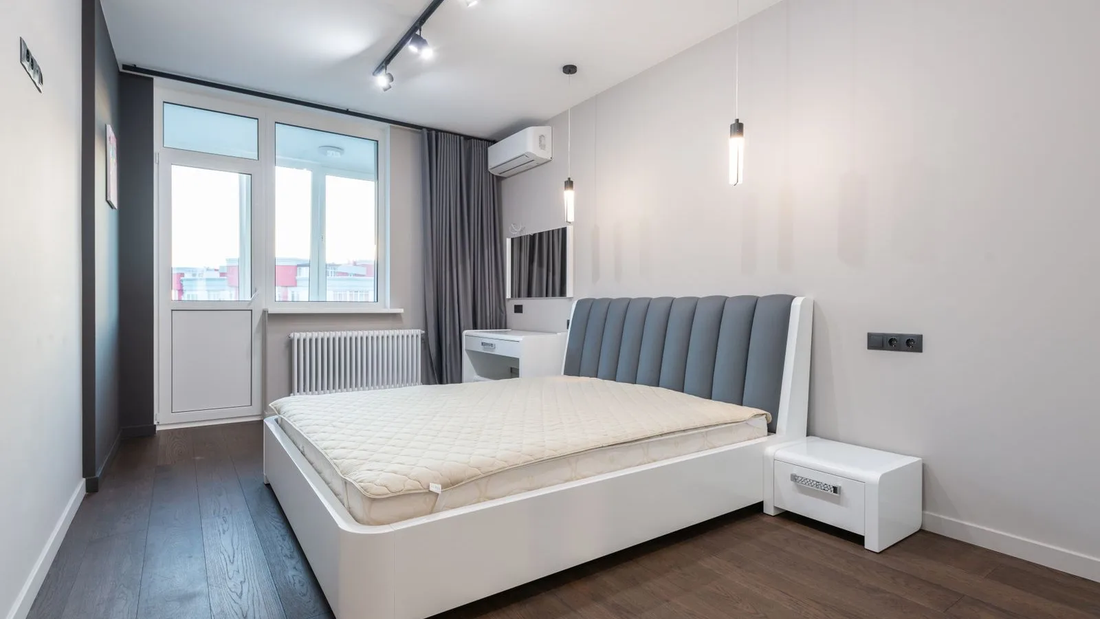 Wall-mounted ductless mini split clearance requirements shown above a bedroom vanity area