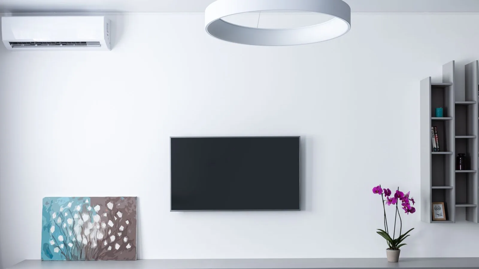 Single ductless mini split indoor unit mounted high on the wall of an open living room