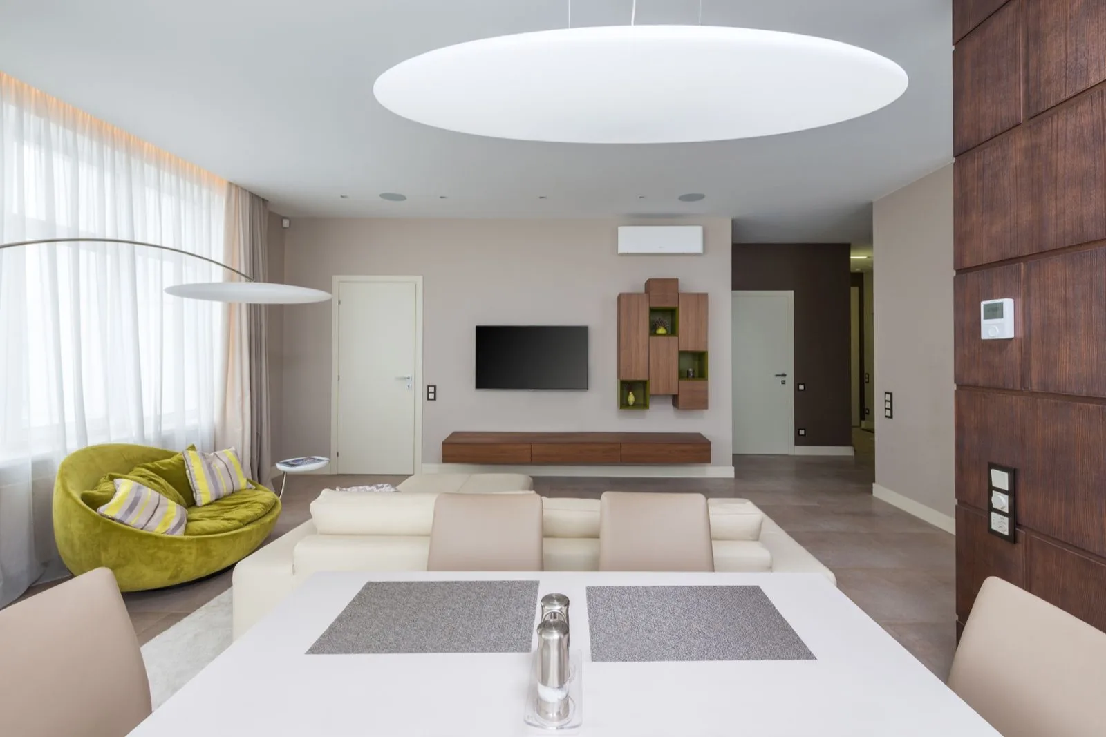Open-plan living and dining room with a single mini split indoor unit on the far wall